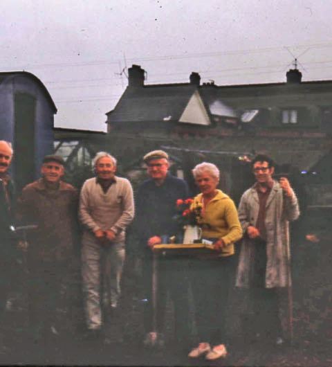 A working party outside the Hut in October 1972. From left to right Eddie Poole (Half off the picture and one of our best ever Show exhibitors), John Townsend, Harry Bottomley (a former Chairman), Harry Brownbill, Mrs. Jeacock (the then President of the Association - providing the refreshments), and Timothy Bower. The top of the Pied Bull is seen behind. 